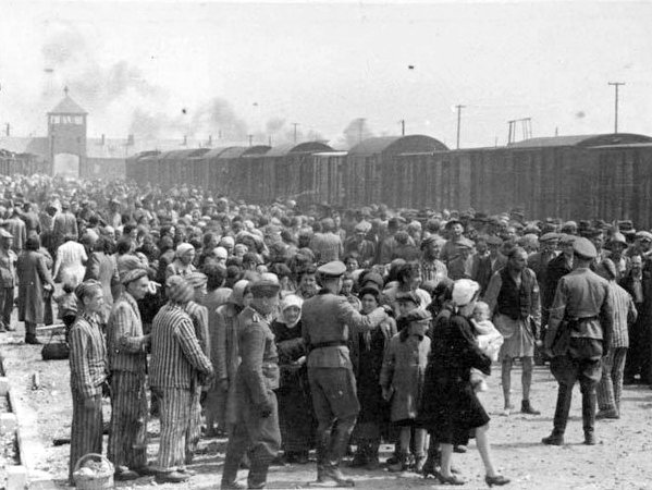 Hungarian Jews on the Judenrampe (Jewish ramp) after disembarking from the transport trains at Auschwitz-Birkenau, May 1944. To be sent rechts! – to the right – meant the person had been chosen as a laborer; links! – to the left – meant death in the gas chambers. (Photo credit: From the Auschwitz Album)