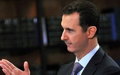 Syrian President Bashar Assad gestures during an interview with Italy's RAI News 24 TV, at the presidential palace in Damascus, Syria, Sept. 29, 2013 (photo credit: AP/SANA)