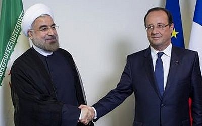 Iranian President Hassan Rouhani, left, shakes hands with French President Francois Hollande during the 68th session of the United Nations General Assembly at UN headquarters last month (photo credit: AP/Craig Ruttle)