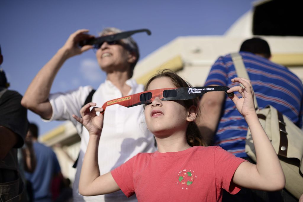People wear special glasses as they watch a partial solar eclipse at the Givatayim Observatory, Sunday, November 3, 2013 (photo credit: Tomer Neuberg/Flash90)