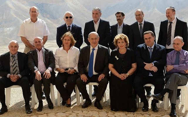 Prime Minister Benjamin Netanyahu sits with cabinet members for a group photo following a special cabinet meeting at the Sde Boker academy to mark 40 years since the passing of Israel's first prime minister David Ben-Gurion, November 10, 2013. (Photo credit: Kobi Gideon/GPO/Flash90)