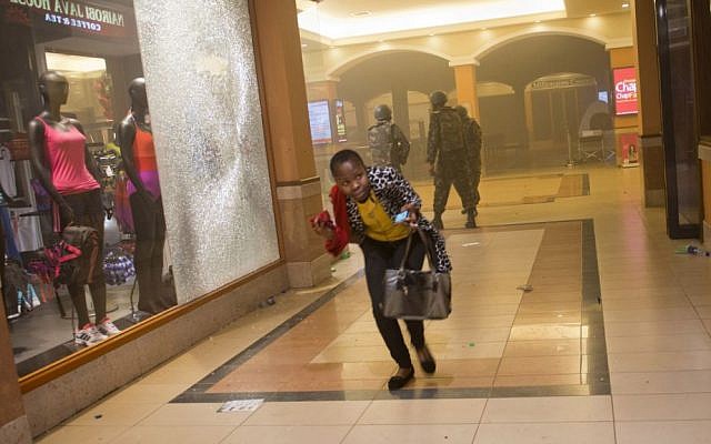 A woman runs for cover during the siege of the Westgate mall in Nairobi, Kenya, last month. (photo credit: AP/Jonathan Kalan/File)