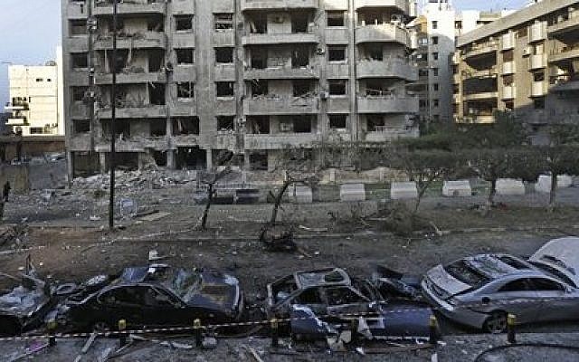 Damaged cars seen in front of a building where many Iranian diplomats live, at the scene of two explosions that struck the day before, near the Iranian embassy, in Beirut, Lebanon, Wednesday, Nov. 20, 2013  (photo credit: AP/Hussein Malla)