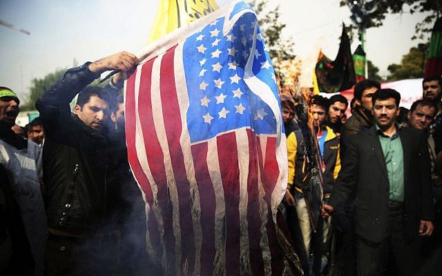 Iranian protesters burn an American flag during an anti-American rally in Tehran, Iran, Monday, Nov. 4, 2013 (photo credit: AP/Ebrahim Noroozi)