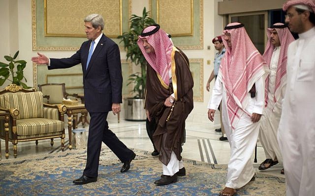 US Secretary of State John Kerry, left, is greeted by Saudi Foreign Minister Prince Saud Al-Faisal bin Abdulaziz al-Saud, after Kerry arrived in Riyadh, Saudi Arabia, FILE-In this Sunday, Nov. 3, 2013 (photo credit: AP/Jason Reed)