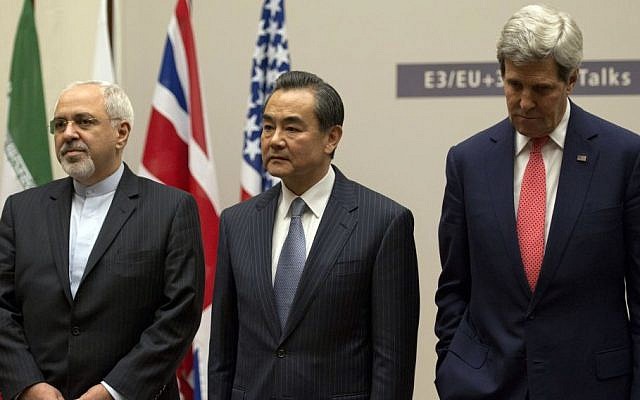 Iranian Foreign Minister Mohammad Javad Zarif, left, Chinese Foreign Minister Wang Yi, center, and US Secretary of State John Kerry attend a ceremony after an agreement was reached on Iran's nuclear program at the United Nations in Geneva, Switzerland, Nov. 24, 2013. (photo credit: AP/Keystone/Martial Trezzini)