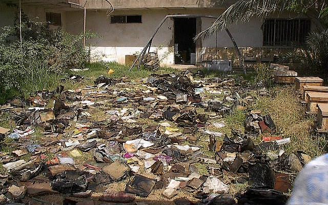 Thousands of waterlogged Jewish books and documents shortly after their discovery in a flooded basement of Saddam Hussein's former intelligence headquarters, May 2003. (Photo credit: courtesy The National Archives)