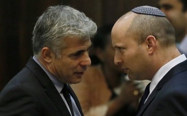 Yair Lapid (left) speaking with Naftali Bennett (right) during a plenum session in the Knesset, April 22, 2013. (Miriam Alster/Flash90)