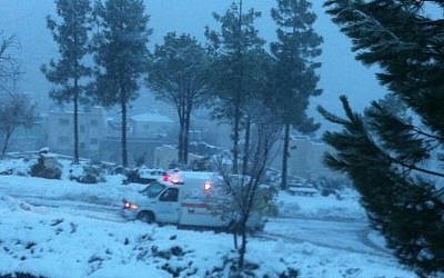 An MDA ambulance driving along a snow-covered route Friday, December 13, 3013. (Photo credit: Magen David Adom in Israel)