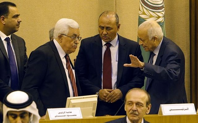 Palestinian Authority President Mahmoud Abbas listens to Arab League Secretary-General Nabil Elaraby, right, as he attends a meeting with Arab foreign ministers requested by Abbas at the league's headquarters in Cairo, Egypt, Saturday, Dec. 21, 2013. (Photo credit: AP/Amr Nabil)