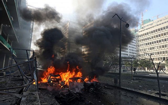 Flames blaze from vehicles at the scene of the explosion in Beirut, Lebanon, Friday, Dec. 27, 2013. (Photo credit: AP/Bilal Hussein)
