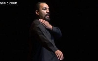 French comedian Dieudonne M'bala M'bala performing the quenelle in 2008 (photo credit: YouTube screenshot)
