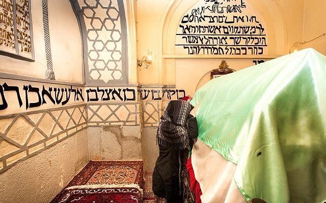 Jewish Iranian woman praying at the tomb of Mordechai and Esther. (Shutterstock)