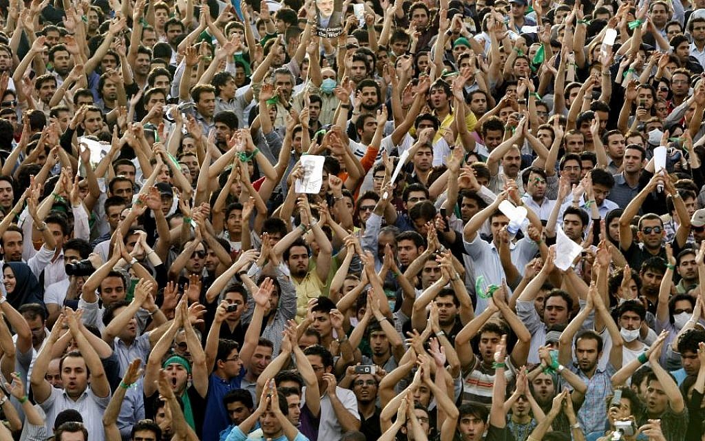 In this Monday, June 15, 2009 file photo, hundreds of thousands of supporters of leading opposition presidential candidate Mir Hossein Mousavi, who claims there was voting fraud in Friday's election, turn out to protest the result of the election at a mass rally in Azadi (Freedom) square in Tehran, Iran. (photo credit: AP Photo/Ben Curtis, File)