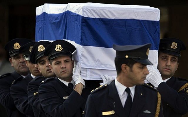 Members of the Knesset guard carry the coffin of Ariel Sharon outside the Knesset in Jerusalem, Monday, January 13, 2014 (photo credit: AP/Bernat Armangue)