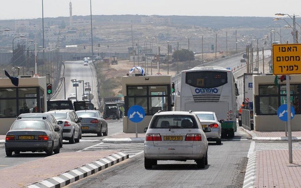 Illustrative photo of Israeli cars driving through a checkpoint on Route 443 in the West Bank (Gili Yaari/Flash90)