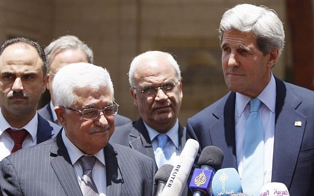 US Secretary of State John Kerry (right) and Palestinian Authority President Mahmoud Abbas (second from left) speak with the press after a meeting in the West Bank city of Ramallah, June 2013. (photo credit: Issam Rimawi/Flash90)