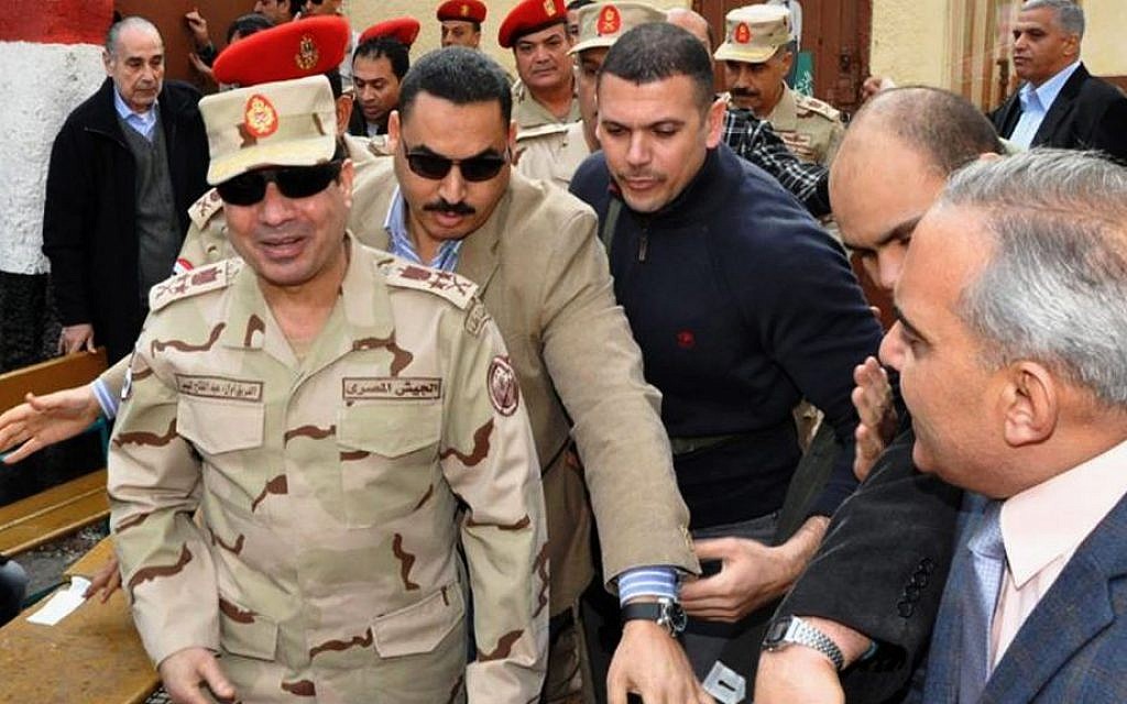 Abdel-Fattah el-Sissi, left, visits a polling site in the Heliopolis neighborhood of Cairo, Egypt, on the first day of voting in the constitutional referendum, on Jan 14, 2014 (photo credit: AP/Egyptian Defense Ministry via Facebook/File)