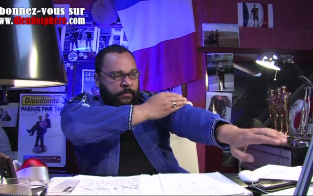 Illustrative photo of anti-Semitic French comedian Dieudonne performing the anti-Semitic quenelle gesture (screen capture: YouTube)