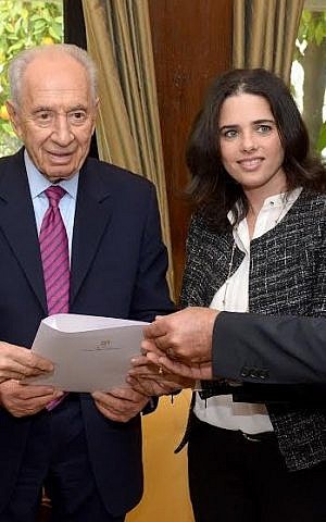 President Peres, flanked by MKs Nachman Shai and Ayelet Shaked, accepts a Knesset petition on behalf of Jonathan Pollard in 2014 (photo credit: Haim Zach, GPO)