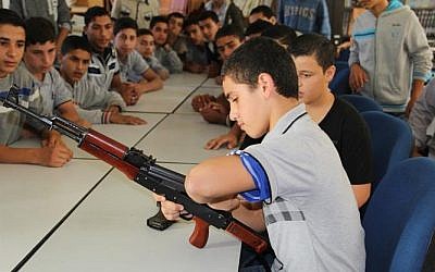 A child practices disassembling an AK-47 during the Hamas-run 'pioneers of liberation' camps in Gaza (photo credit: Hamas interior ministry website)