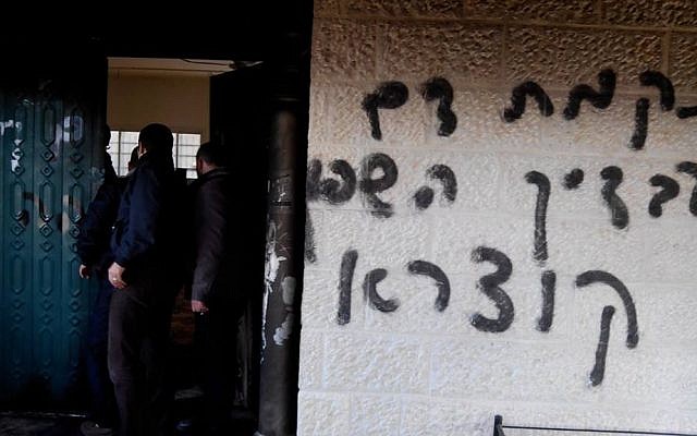 Graffiti reading "We will avenge your spilled blood, Qusra" on the walls of a mosque that was set ablaze in an apparent "price tag" attack in the Palestinian village of Deir Istiya in January 2014. (photo credit: Zakariya/Rabbis for Human Rights)
