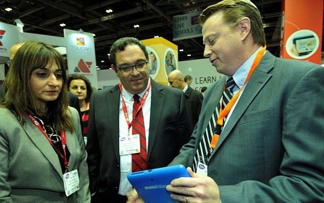 Education Minister Director Michal Cohen (L.) and Education Minister Shai Piron (C.) look on as Fourier CEO Ken Zwiebel demonstrates an Einstein tablet+ at the Bett Show in London last week (Photo credit: Courtesy)