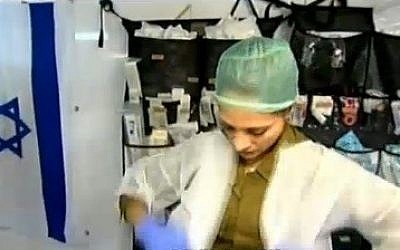Military nurse Shireen Parizadeh prepares to treat a Syrian patient. (photo credit: screen capture, Channel 2)