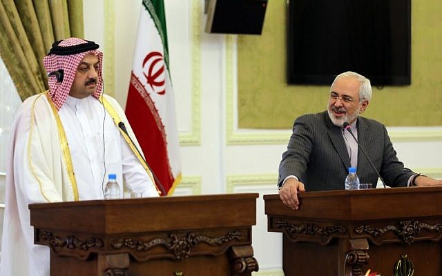 Qatar's Foreign Minister Khalid al-Attiyah (left) holds a joint press conference with his Iranian counterpart Mohammad Javad Zarif on February 26, 2014 in Tehran. (photo credit: AFP/Atta Kenare)