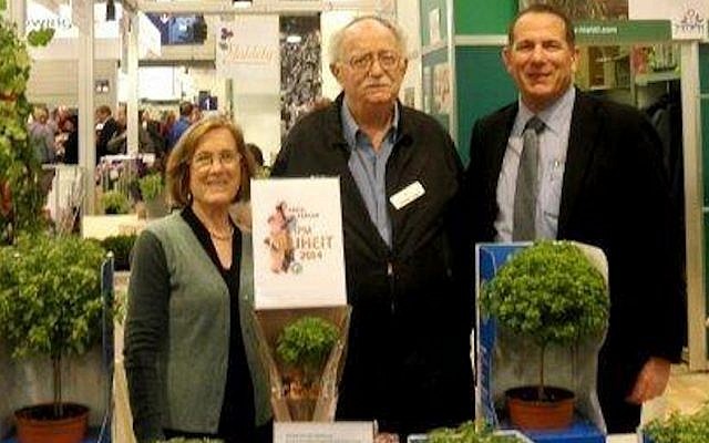 Yechezkel Dagan (C.), flanked by Hishtil executives Reut Rothman (L.) and Ronny Hasid (R.), present Hishtil's Basil Tree at IPM Essen (Photo credit: Courtesy)