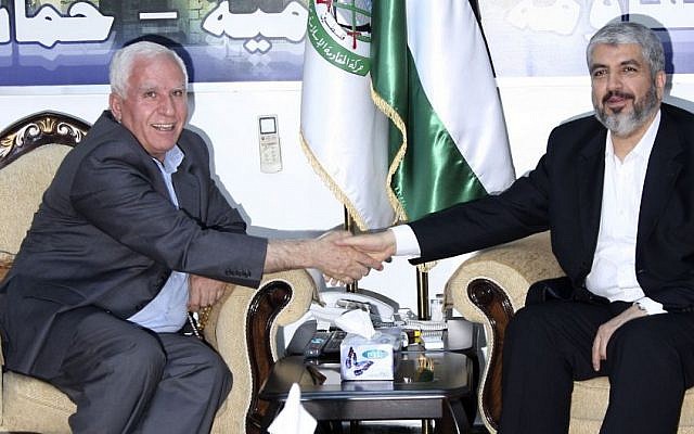 Hamas leader Khaled Meshaal, right, shakes hands with Fatah official Azzam al-Ahmad during their meeting in Damascus, Syria, September 2010 (photo credit: AP/Bassem Tellawi)