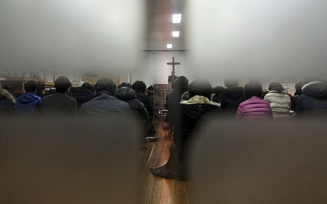 Members from Jincheon Jungang Presbyterian Church attend a service at their church in Jincheon, South Korea, Monday, February 17, 2014, the day after a Sinai terror group targeted a bus filled with Korean members of the church at Taba, Egypt. (photo credit: AP/Yonhap, Kim Hyung-woo)