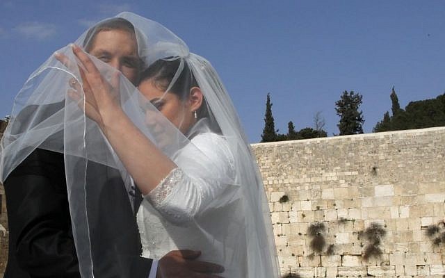 Illustrative photo of a couple having a wedding picture taken at the Western Wall, in the Old City of Jerusalem, April 2011. (Nati Shohat/Flash90)
