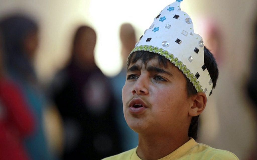 Syrian refugee Majd Ammari, 13, performs the role of King Lear during a rehearsal at the sprawling Zaatari refugee camp in the Jordanian desert near the border with Syria, March 8, 2014. (photo credit: AFP/Khalil Mazraawi)