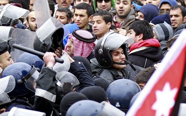 Jordanian riot police confront protesters during a demonstration in front of the Israeli Embassy in Amman on Friday (photo credit: AFP/Khalil Mazraawi)