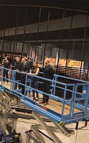 Cast and production crew examine the still unfinished Amsterdam theater that is being built as a venue for the play “ANNE” on March 12, 2014. (photo credit: Cnaan Liphshiz/JTA) 