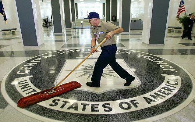 In this March 3, 2005, file photo a workman quickly slides a dust mop over the floor at the Central Intelligence Agency headquarters in Langley, Va., near Washington. (photo credit: AP/J. Scott Applewhite, File)