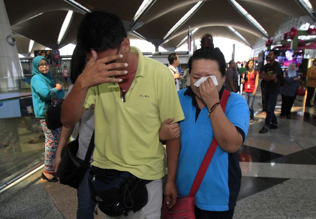 A woman wipes her tears after walking out of the reception center and holding area for family and friends of passengers aboard a missing Malaysia Airlines plane, at Kuala Lumpur International Airport in Sepang, Saturday, March 8, 2014. (photo credit: AP Photo/Lai Seng Sin) 