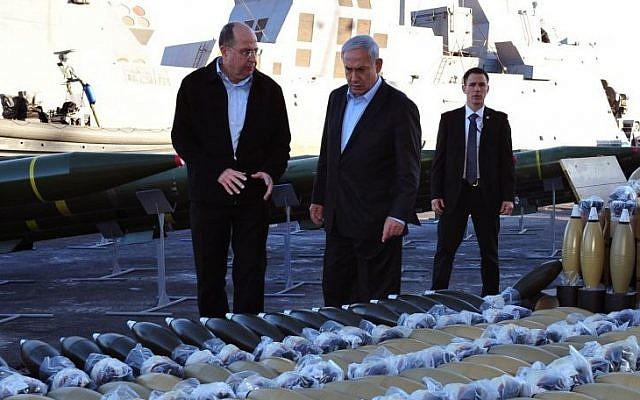 Defense Minister Moshe Yaalon (left) and Prime Minister Benjamin Netanyahu examine dozens of mortar shells and rockets on display, at a military port in the Southern Israeli city of Eilat, that were seized from the Panama-flagged Klos-C cargo ship in the Red Sea, and which according to the Israeli military was carrying dozens of advanced rockets from Iran destined for Palestinian terrorists in Gaza. March 10, 2014. (Photo credit: Ariel Hermoni/Ministry of Defense/Flash90)