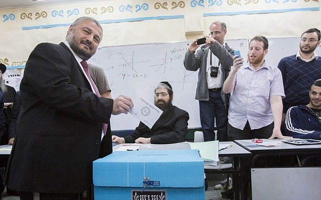 Bet Shemesh mayoral candidate Moshe Abutbul casts his vote at a polling station, during the second round of the local elections in the city, March 11, 2014. (Yonatan Sindel/Flash90)