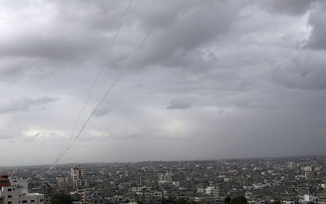 A trail of smoke from rockets fired by Palestinians from Gaza toward Israel is seen above Gaza City on Wednesday, March 12, 2014. (photo credit: AP/Adel Hana)