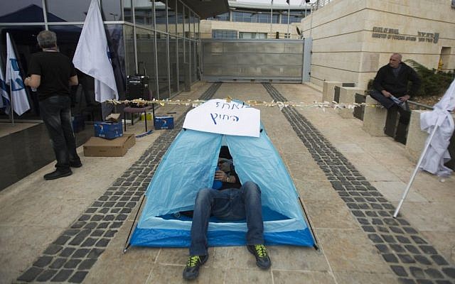 A Foreign Ministry worker lying in a tent as he strike outside the Foreign Ministry offices in Jerusalem, on March 24, 2014. (photo Yonatan Sindel/Flash90)