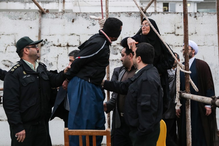 Balal Abdullah, who killed Iranian youth Abdolah Hosseinzadeh in a street fight with a knife in 2007, is rescued from the gallows by the mother of his victim during his execution ceremony in the northern city of Nowshahr on April 15, 2014 (photo credit: AFP/Arash Khamooshi/ISNA)