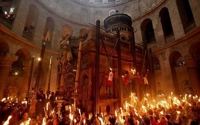 Christian worshippers gather in the Church of the Holy Sepulcher in Jerusalem's Old City on April 19, 2014 (Gali Tibbon/AFP)