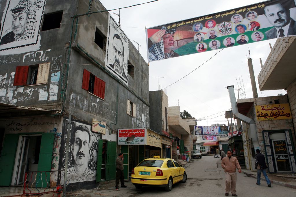 Graffiti and banners are seen in Deheishe refugee camp, near Bethlehem (photo credit: Maya Levin/Flash90/File)