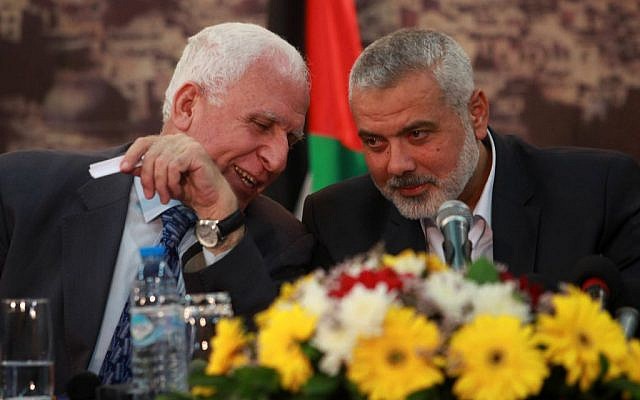 Head of the Hamas government Ismail Haniyeh (right) and senior Fatah official Azzam al-Ahmad (left) attend a news conference as they announce a reconciliation agreement in Gaza, on April 23, 2014. (Abed Rahim Khatib/Flash90)