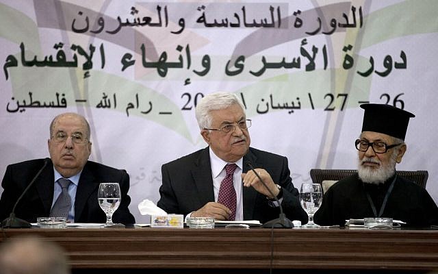 Palestinian Authority President Mahmoud Abbas speaks during a meeting of the Palestinian Central Council, a top decision-making body, at his headquarters in the West Bank city of Ramallah, Saturday, April 26, 2014. Abbas said any unity government with the Islamic extremist Hamas would follow his political program, an apparent attempt to reassure the West. Israel’s leaders have accused Abbas of choosing Hamas over possible peace with Israel. (photo credit: AP Photo/Majdi Mohammed)
