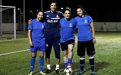 From left to right, Israeli Arab players Hanin Gamal Nasser, Walaa Hussien and Noura Abu-Shanab pose with their coach during a practice session in Petah Tikva, Israel. (AP Photo/Tsafrir Abayov)