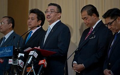 Malaysian Minister of Defence and Acting Transport Minister Hishammuddin Hussein (C) speaks during a press conference on the missing Malaysia Airlines flight MH370 in Kuala Lumpur on May 15, 2014, the day the hunt for the missing passenger jet in the Indian Ocean was put on hold. (photo credit: AFP Photo/Mohd Rasfan)