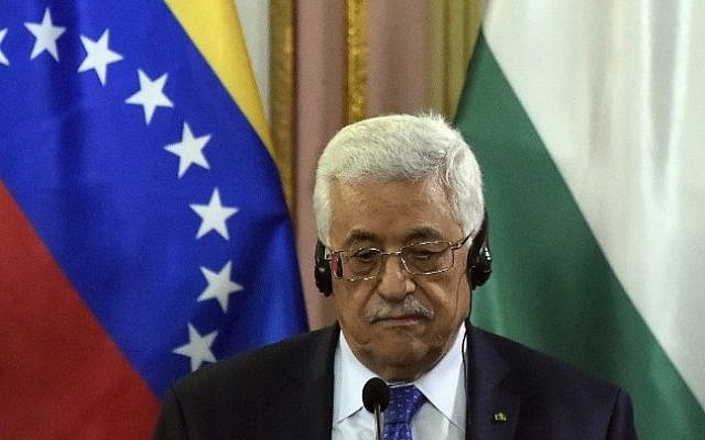 Palestinian leader Mahmoud Abbas listens during a meeting with Venezuela's President Nicolas Maduro at the Miraflores Palace in Caracas on May 16, 2014. photo credit: AFP/JUAN BARRETO)